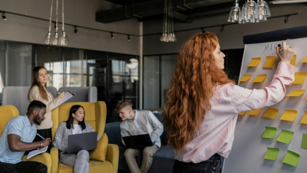 Woman writing on whiteboard